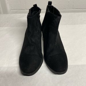 Women’s black suede ankle booties.